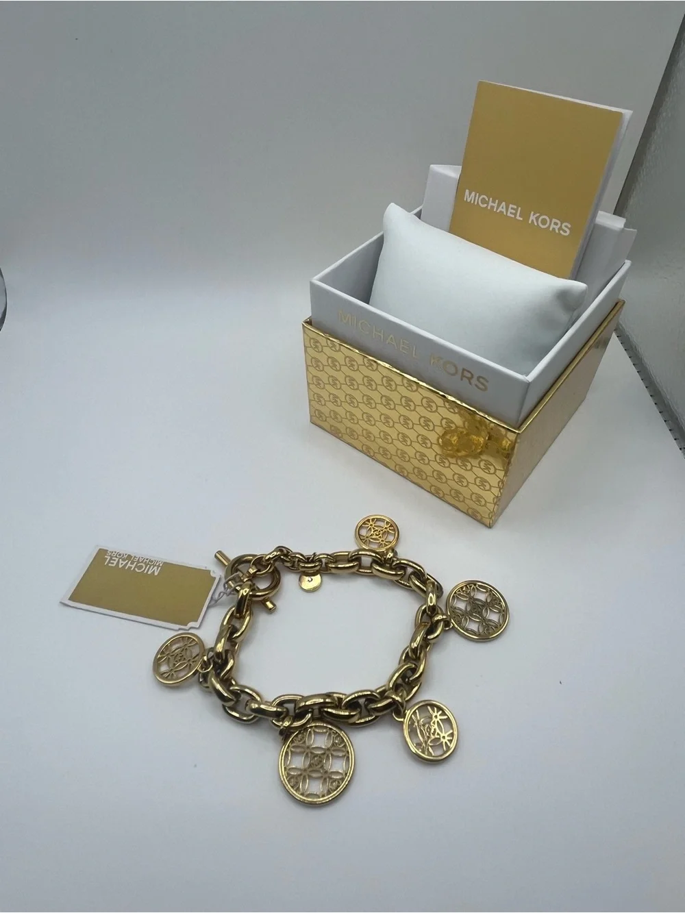 Michael Kors Gold Tone Charm Toggle Bracelet MK Logo Medallion NWT in Box